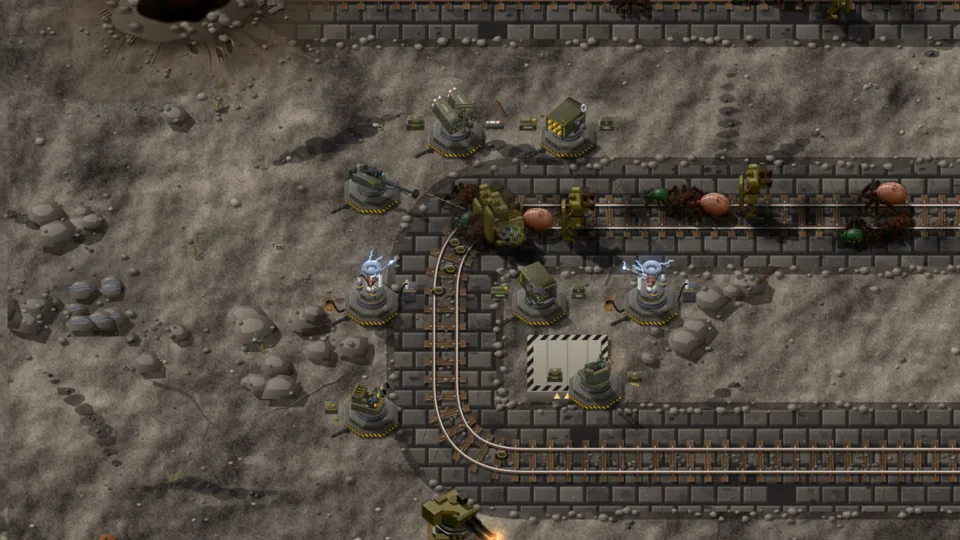 Bobinas Tesla e torres protegem uma linha férrea que serpenteia pela rochosa Zona de mineração.